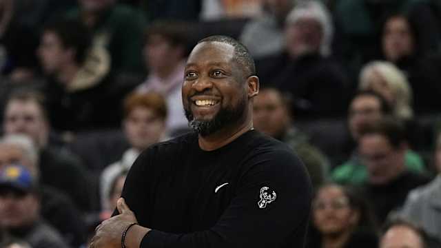 Milwaukee Bucks head coach Adrian Griffin smiles 